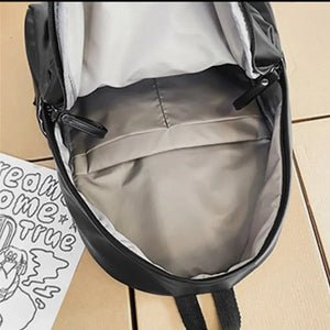 Black leather backpack interior with zippered compartment and front pocket detail.