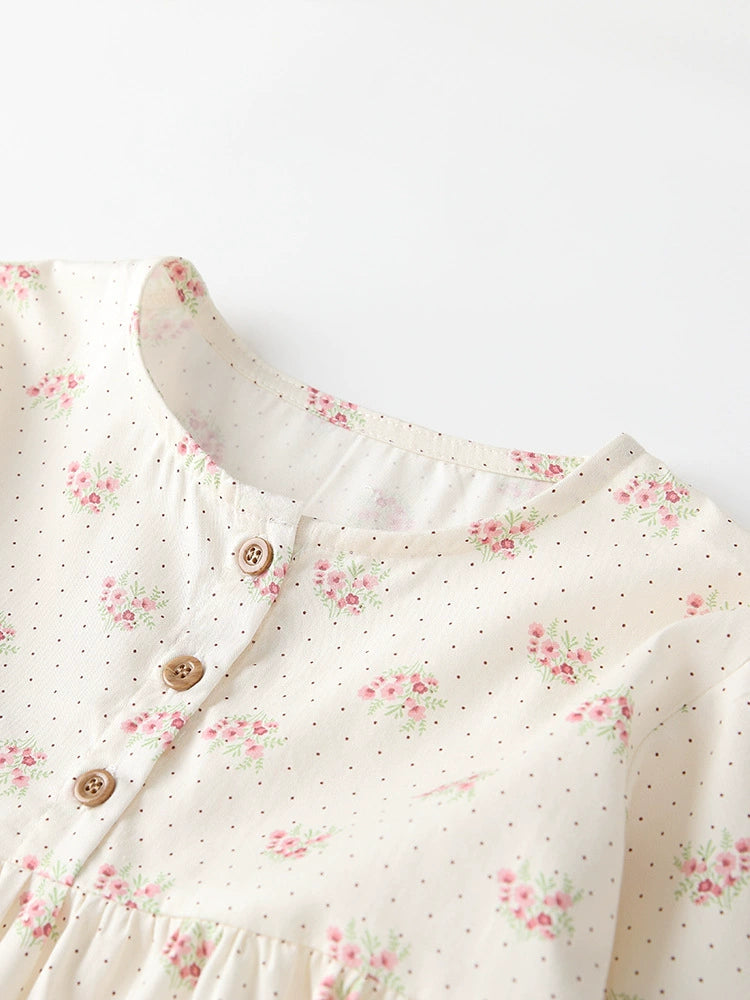 Cream cotton toddler dress with pink floral and dot print, button front detail.