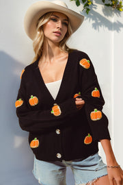 Black V-neck cardigan with embroidered pumpkins, buttoned, 100% polyester.