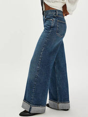 Cuffed wide-leg denim trousers in dark blue with a relaxed fit and large cuffs.