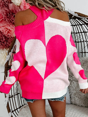 Hot pink and white acrylic sweater with open shoulders and a heart motif pattern.