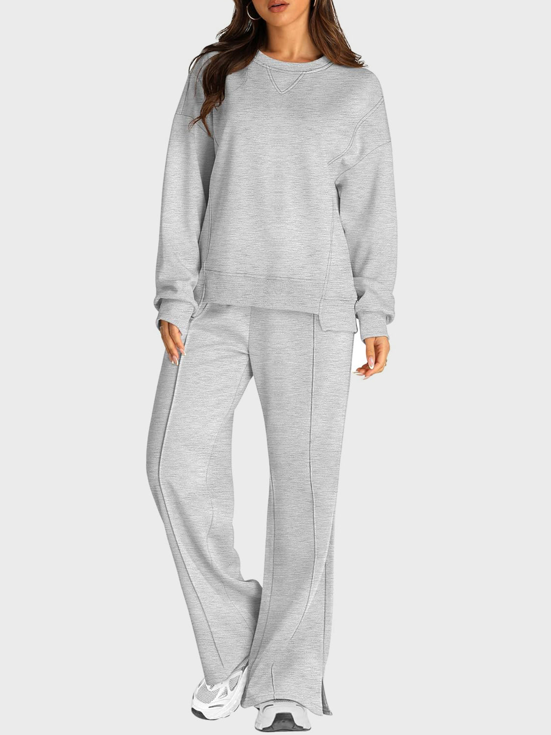 Light gray seamed loungewear set with crewneck sweatshirt and slit-front wide-leg trousers.