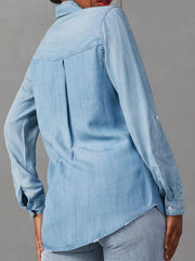 Light blue washed denim utility shirt with buttoned cuffs and back pleat detail.