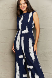Navy brushstroke print jumpsuit with keyhole back detail and wide legs.