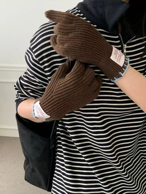 Brown ribbed knit gloves with scalloped cuff and light blue trim detail.