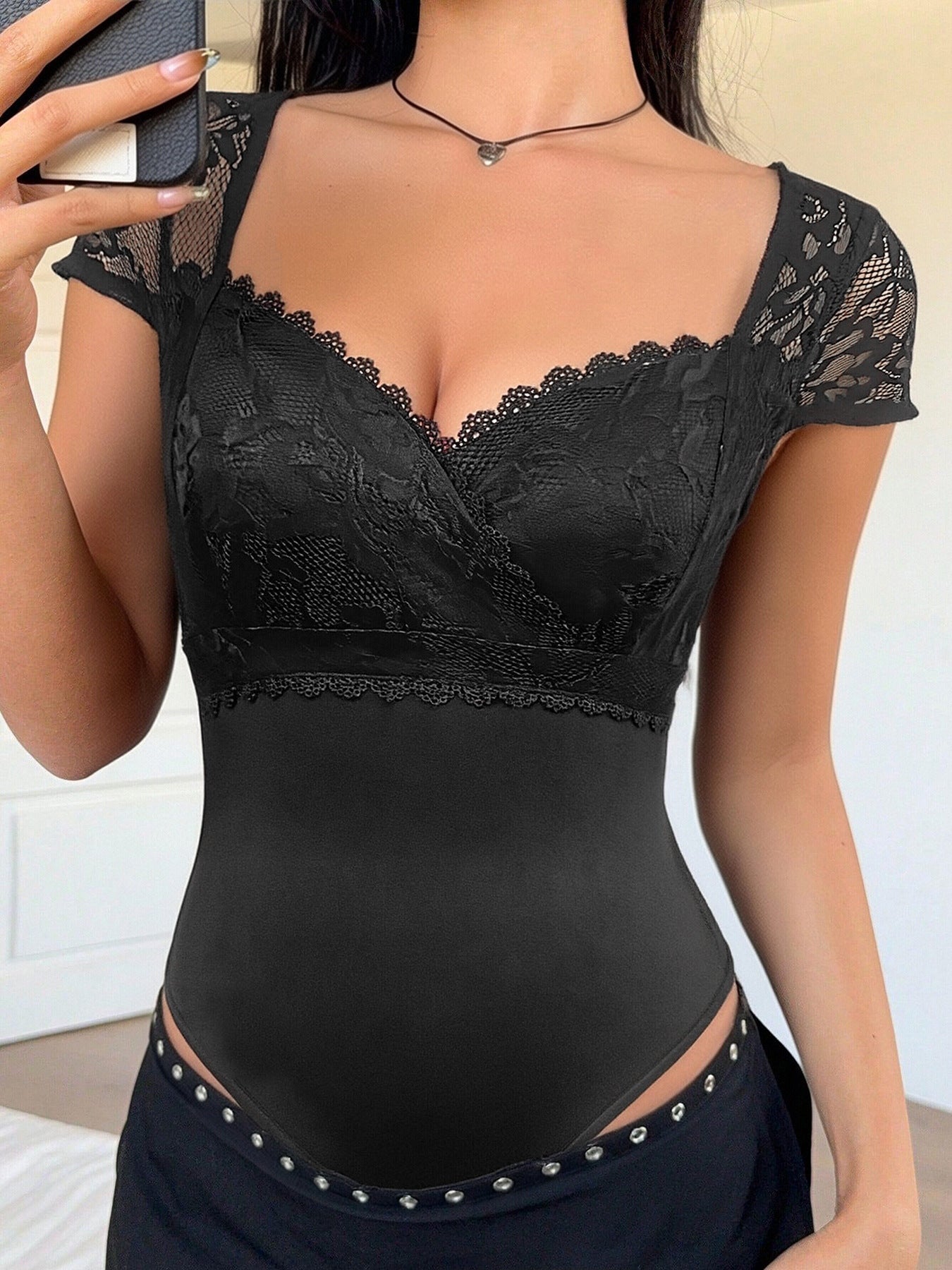 Black lace sweetheart neckline bodysuit with cap sleeves and scalloped trim