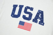 White ribbed knit sweatshirt with distressed blue USA graphic and American flag detail.
