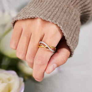 Intertwined trio diamond ring in gold with pave diamond accents.