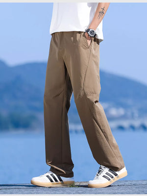 Men's brown relaxed fit lightweight joggers with pockets, styled casually.