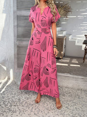 Hot Pink geometric print wide-leg jumpsuit with short sleeves and a V-neck.
