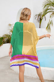 Cropped knit cover-up with scoop neck, half sleeves, and colorful striped hem.