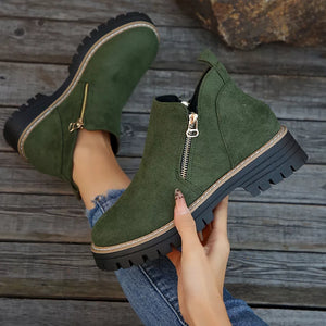 Green suede ankle boots with side zipper and rugged sole.