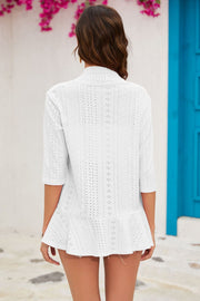 White perforated peplum sleeve cardigan with 3/4 sleeves and a ruffled hem.