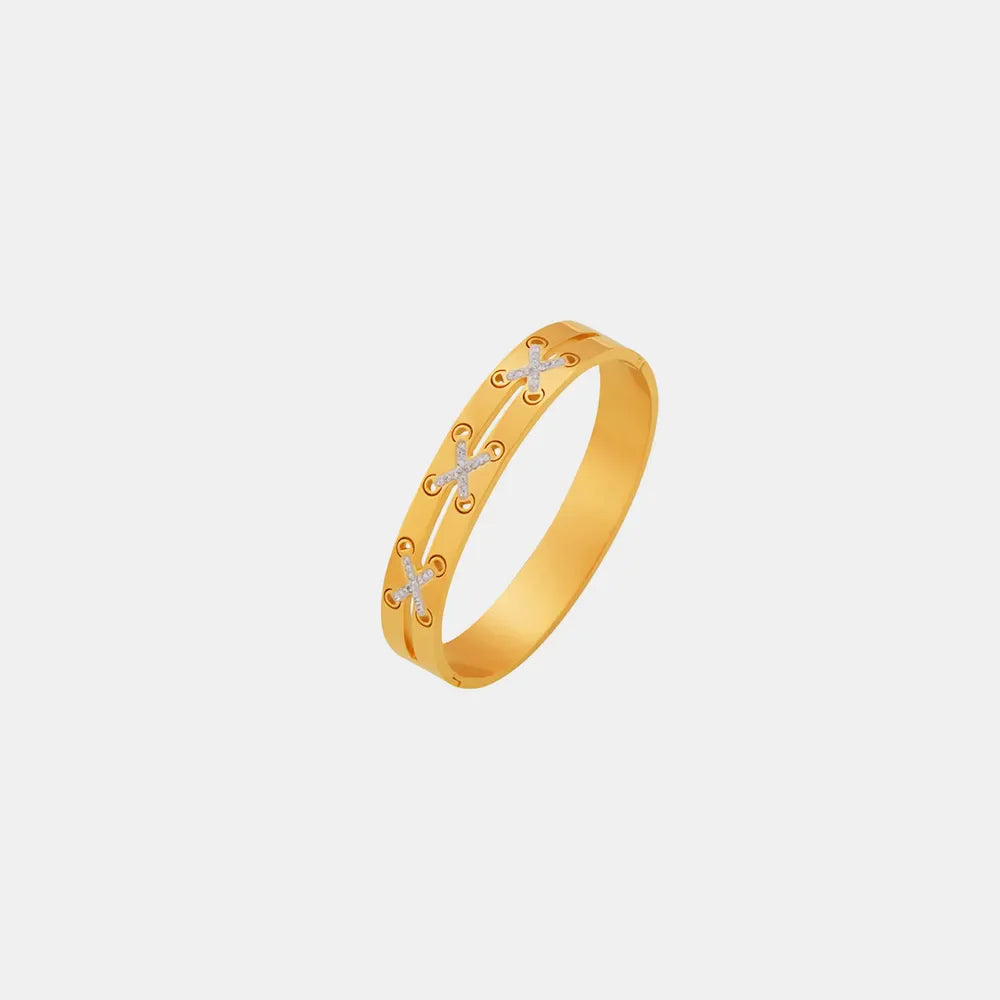 Gold cuff bracelet with diamond laced crisscross detail