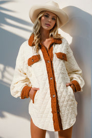 Diamond quilted shacket in cream with contrast trim and buttoned pockets.