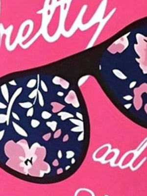 Baby tee with sunglasses graphic and floral print detail on pink background