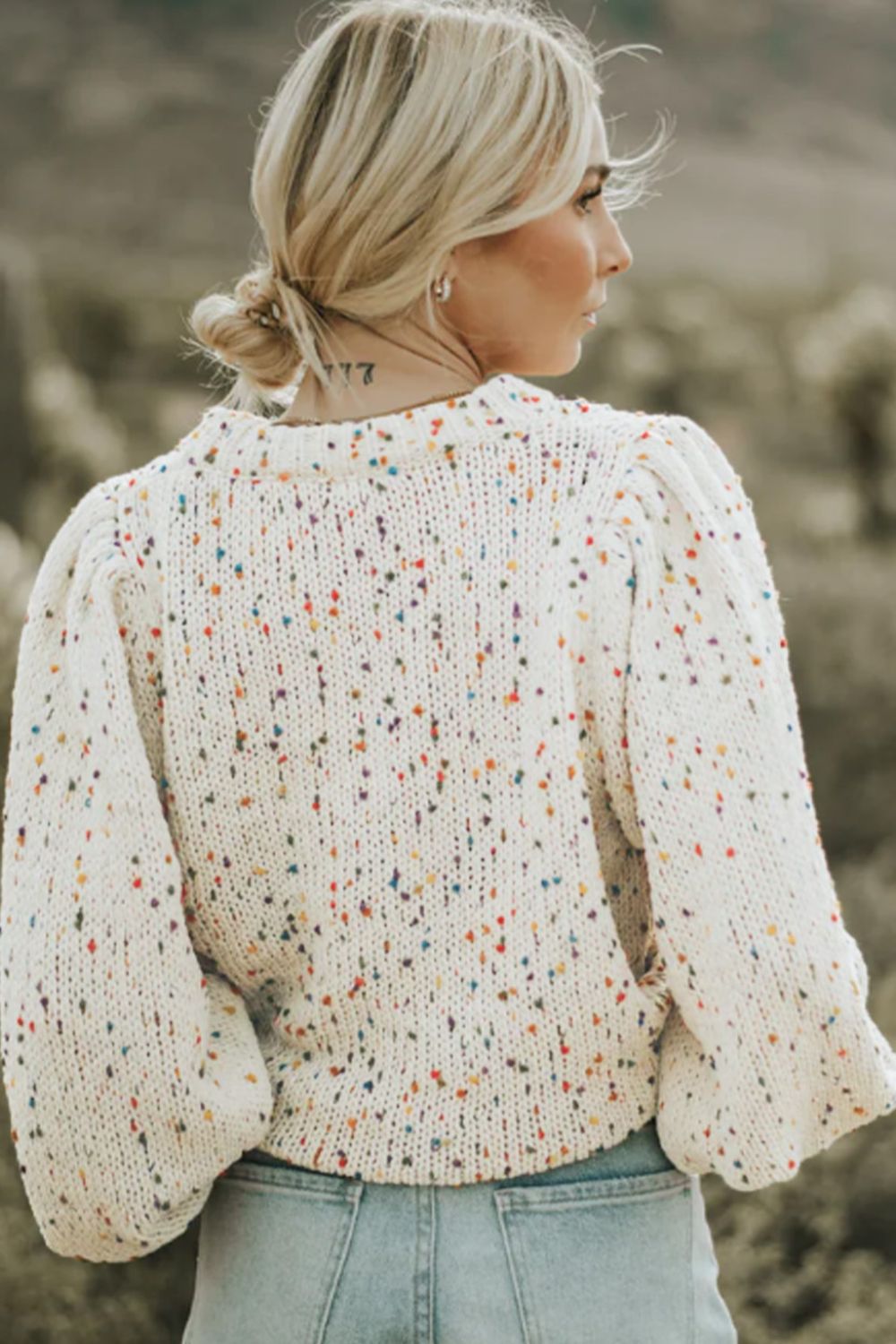 Speckled puff sleeve knit sweater in cream with colorful speckles and a crew neck.