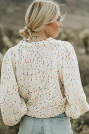 Speckled puff sleeve knit sweater in cream with colorful speckles and a crew neck.
