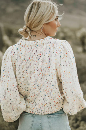 Speckled puff sleeve knit sweater in cream with colorful speckles and a crew neck.