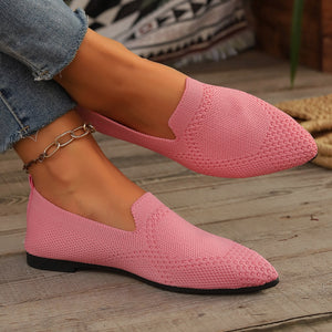 Pink breathable pointed-toe knit flats with a casual slip-on style.