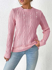 Dusty pink cable knit sweater with pearl embellishments and crew neck.