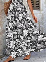 Black tiered maxi dress with smocked bodice and white leaf print.