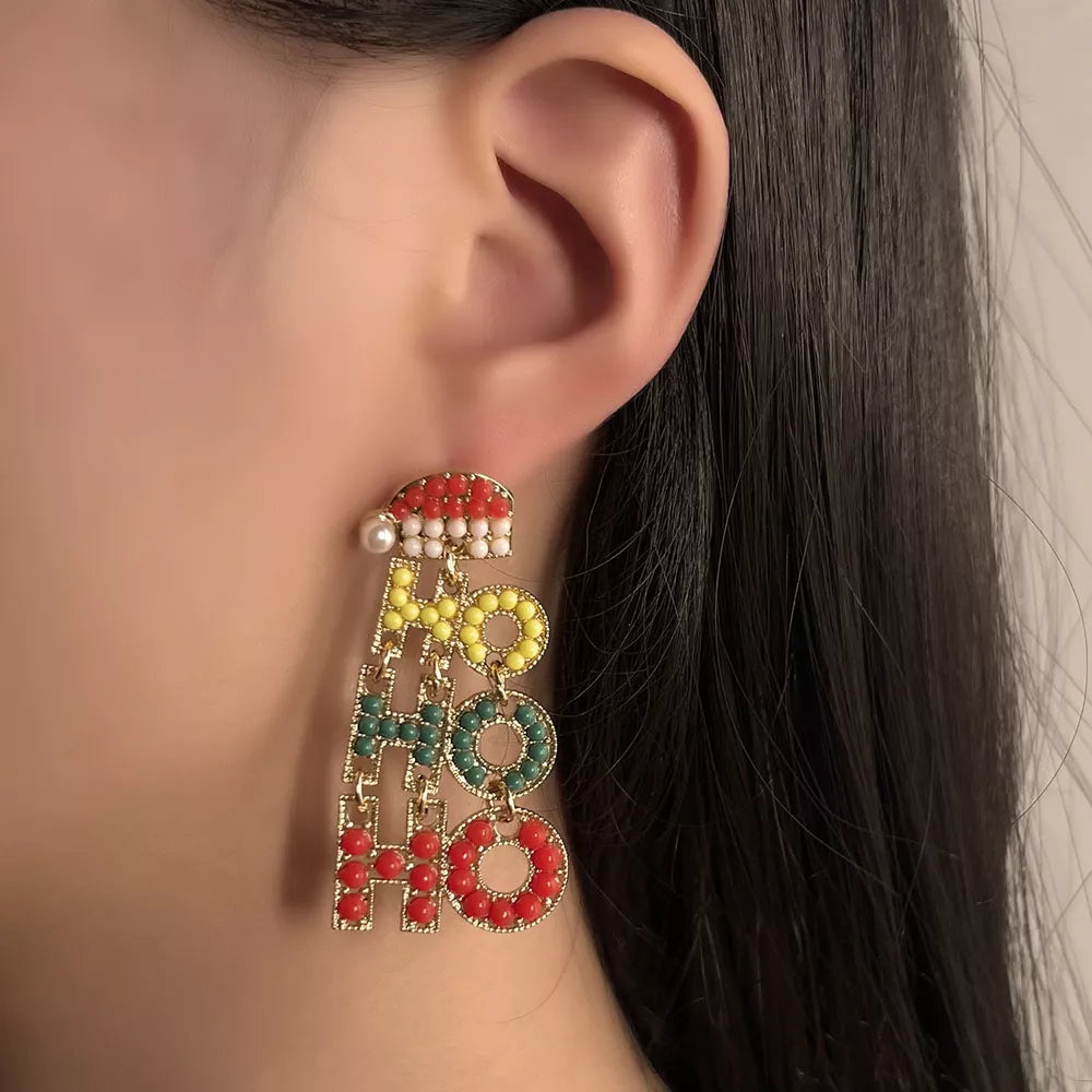 Festive "HO HO HO" drop earrings with pearl and colorful millet beads, 18k gold accent.