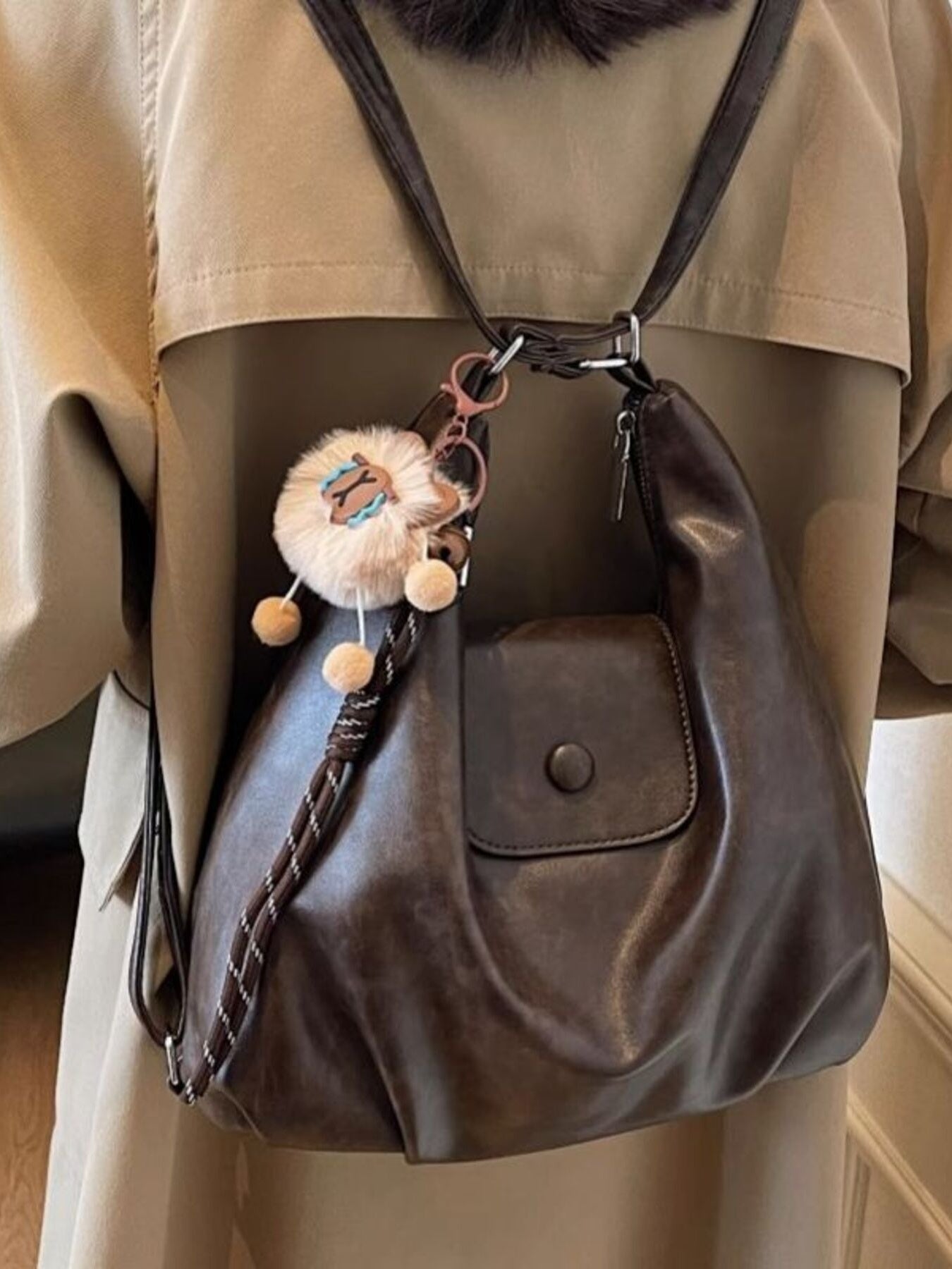 Vintage pu leather shoulder bag in olive brown with a fluffy sheep charm and braided strap detail.