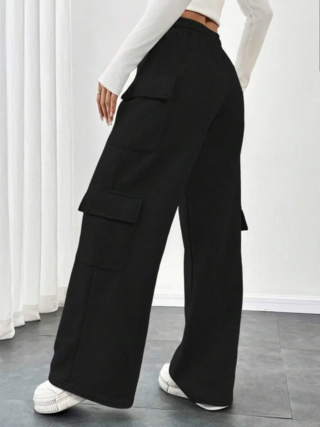 Black relaxed fit cargo pants with drawstring and multiple pockets.