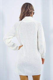 White knit turtleneck mini dress with long sleeves and a ribbed texture.