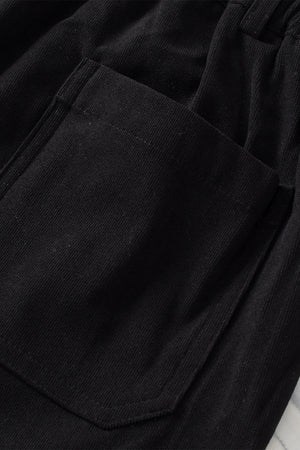 Black seamed front wide leg trousers with a visible pocket detail.
