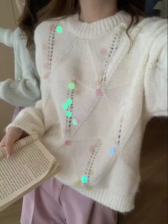 Ivory diamond knit sweater with colorful sequin embellishments and open knit details.