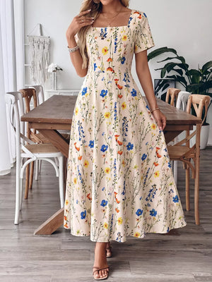 A-line maxi dress with square neckline and colorful floral print on cream background.