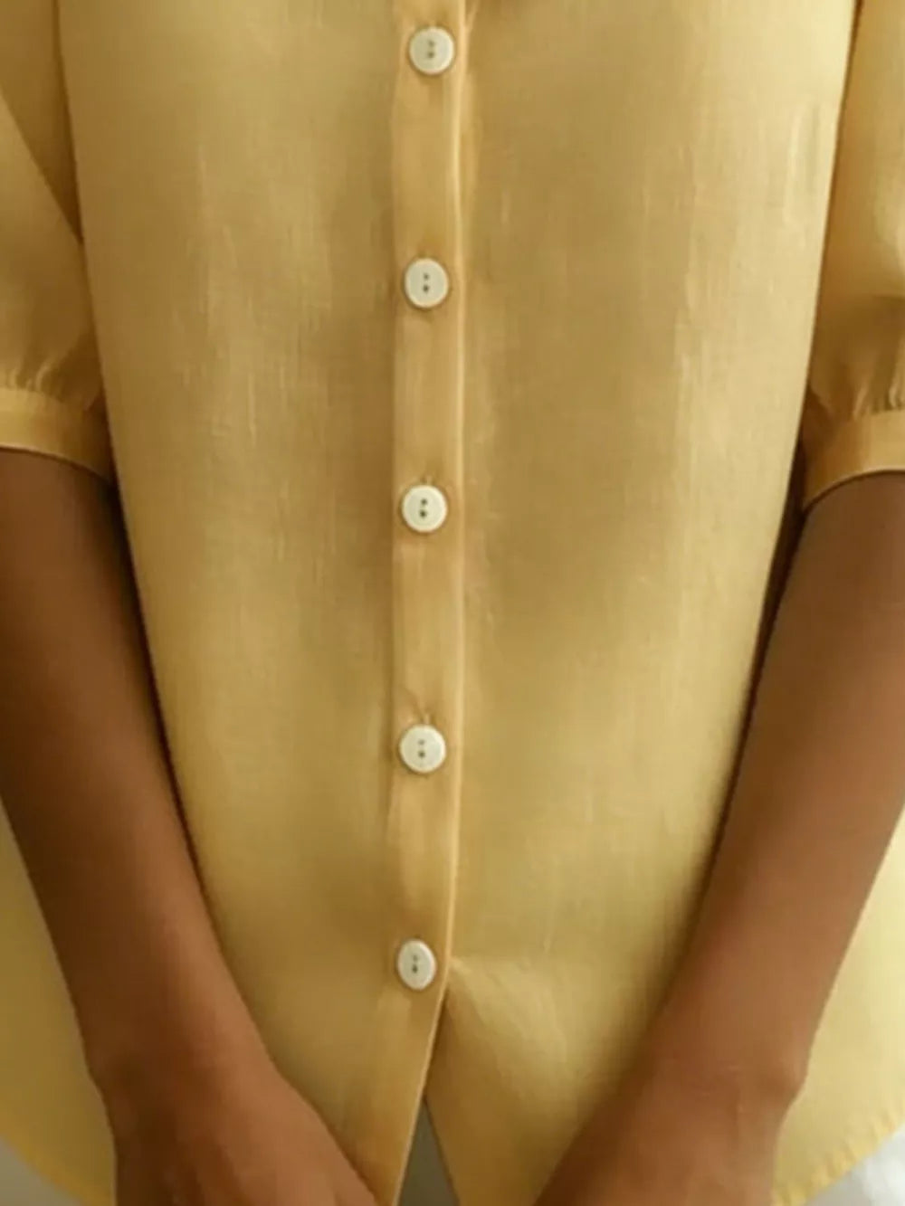 Pastel yellow button-down shirt with puff sleeves and a Peter Pan collar.
