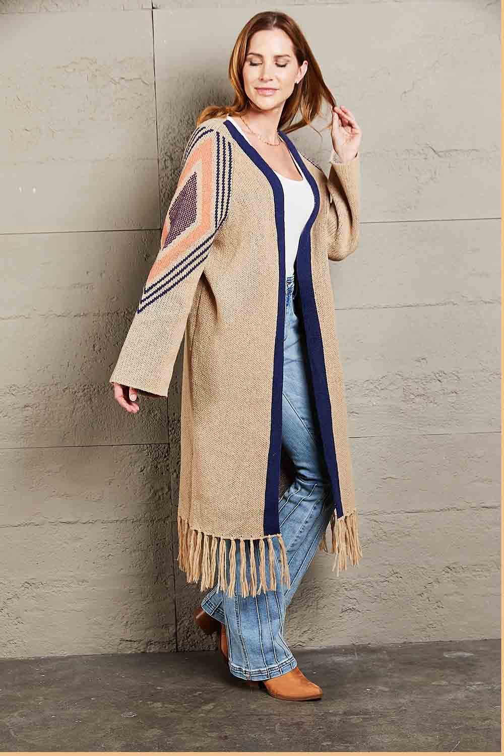 Khaki long cardigan with geometric trim, navy blue trim, and fringed hemline.