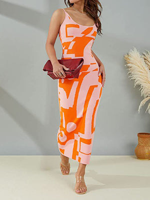 Geometric knit maxi slip dress in orange and pink abstract print with spaghetti straps.
