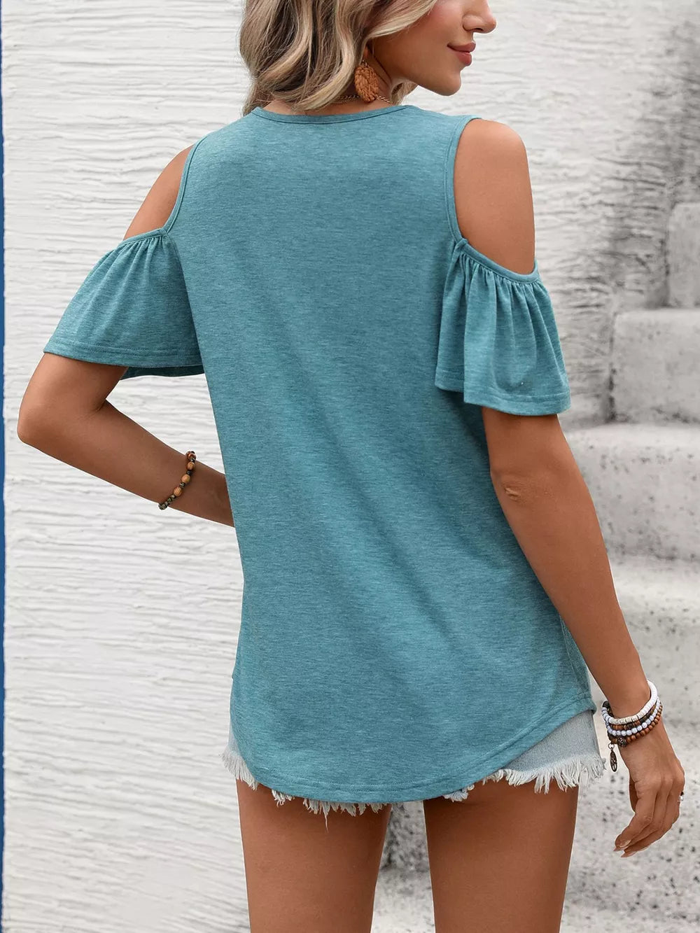 Blue-green ruched cold shoulder t-shirt with ruffled short sleeves.