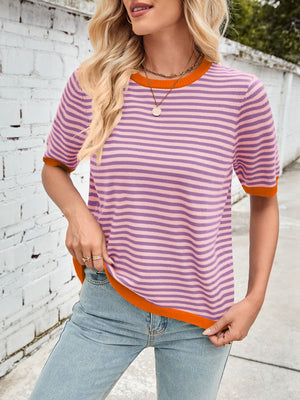 Striped knit tee with orange trim and crew neck, styled with jeans.
