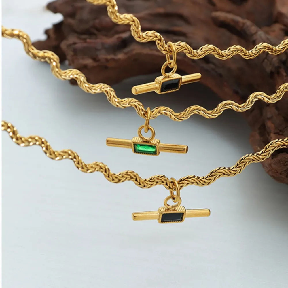 Gold rope chain necklace with emerald and black bar pendants