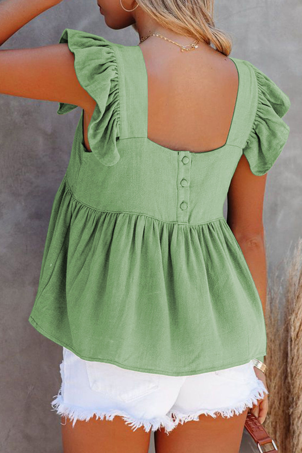 Light Green babydoll linen top with flutter sleeves and button back detail.