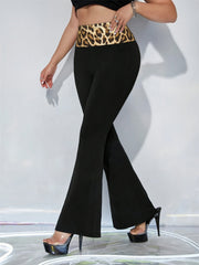 Black flare trousers with a bold leopard print waistband.