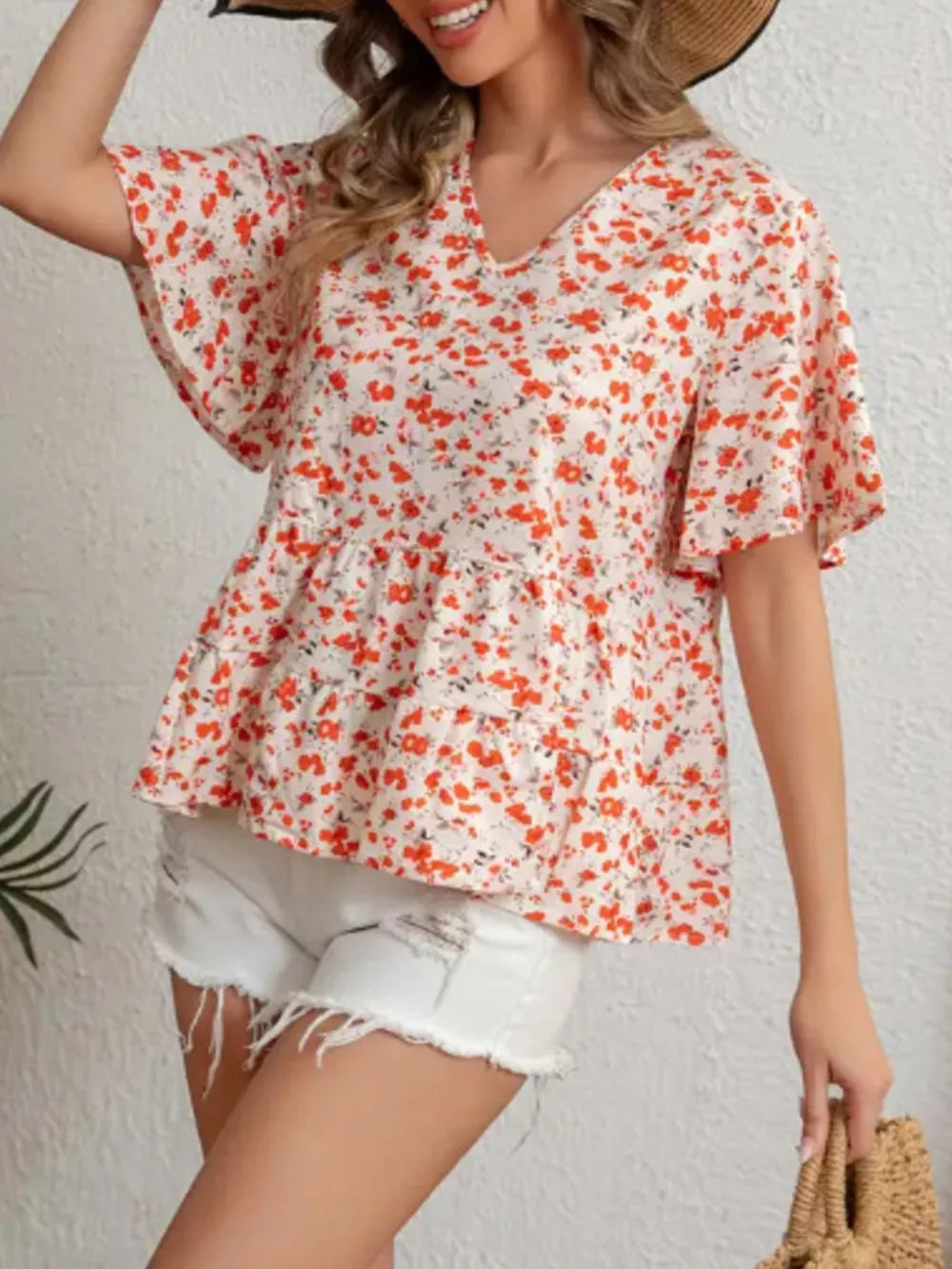 Vibrant floral peplum blouse with ruffle sleeves and v-neck