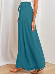 Textured drawstring palazzo trousers in deep teal with pockets and a cinched waist.