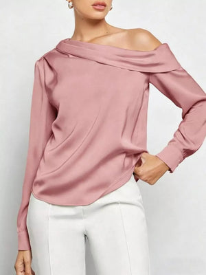 Elegant one-shoulder satin shirt in dusty rose with a draped neckline and long sleeves.