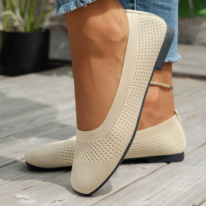 Beige knit square-toe flats with a flexible sole.