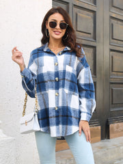 Oversized blue plaid shacket with gold buttons and chest pockets.