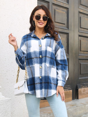 Oversized blue plaid shacket with gold buttons and chest pockets.