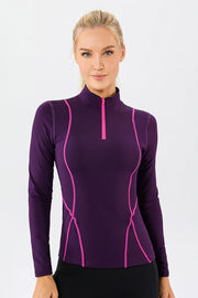 Violet athleisure zip-neck top with pink seam details and long sleeves.