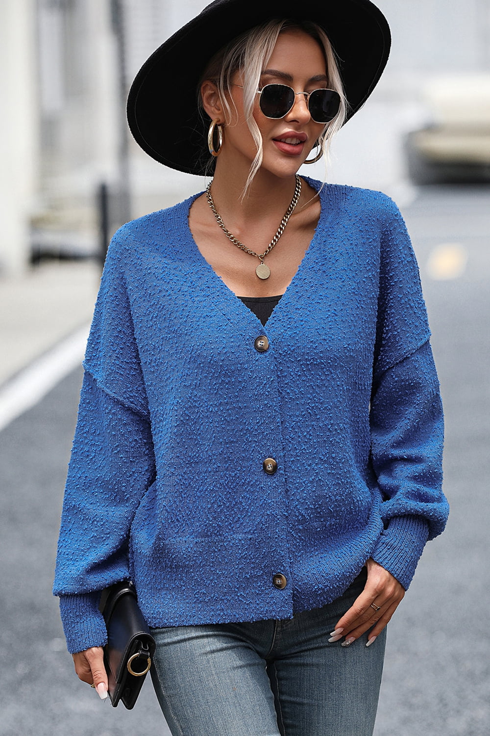 Blue textured bouclé button-down cardigan with V-neck and long sleeves.