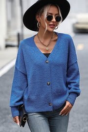 Blue textured bouclé button-down cardigan with V-neck and long sleeves.